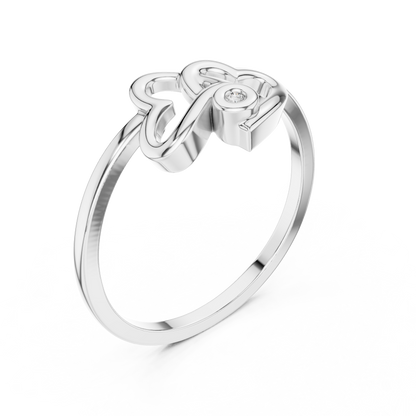 A Sculptural Double Heart Ring with a Radiant Diamond Accent